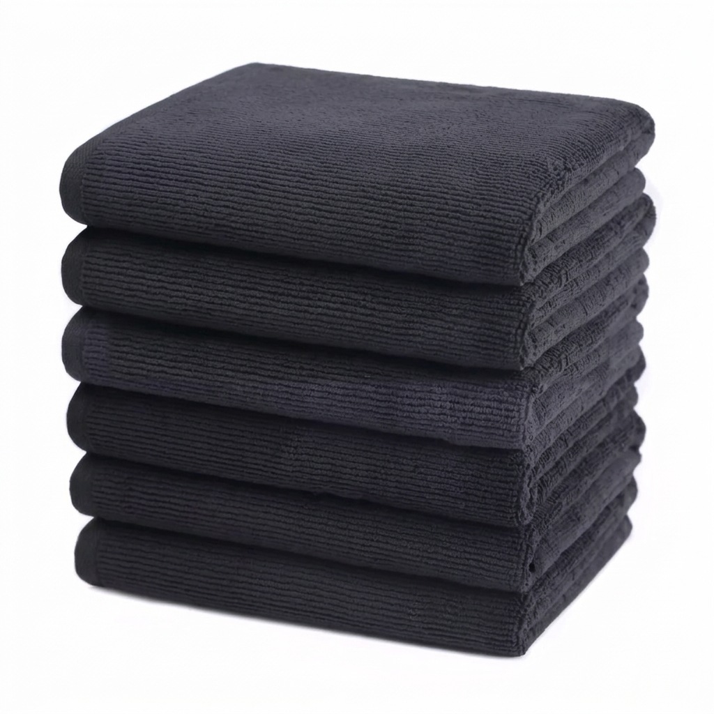 Stack of black microfibre salon towels, 10 pack