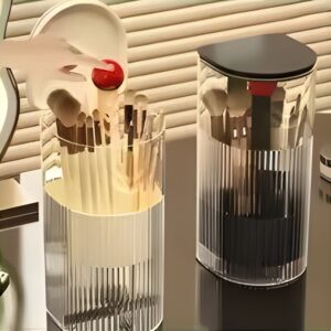 Hand pressing the lid of a lifting makeup brush holder to raise the brushes
